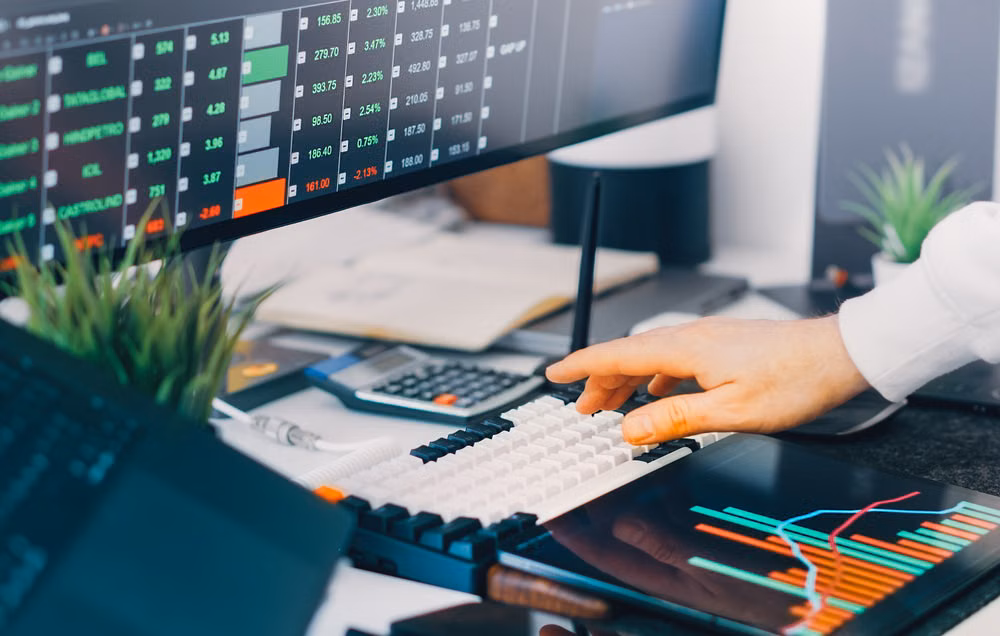 Professional workspace with live monitoring dashboards on screens