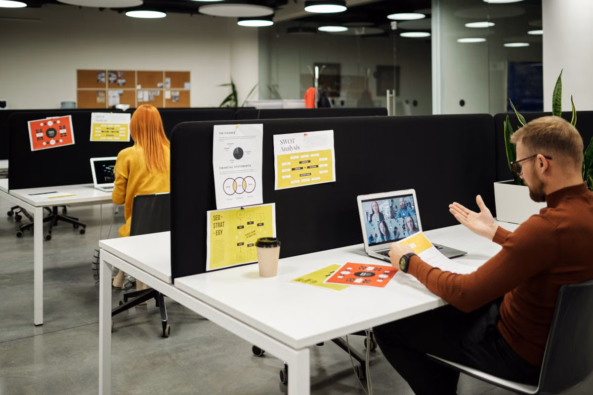 Colleague collaborating virtually on a video call at a modern workspace