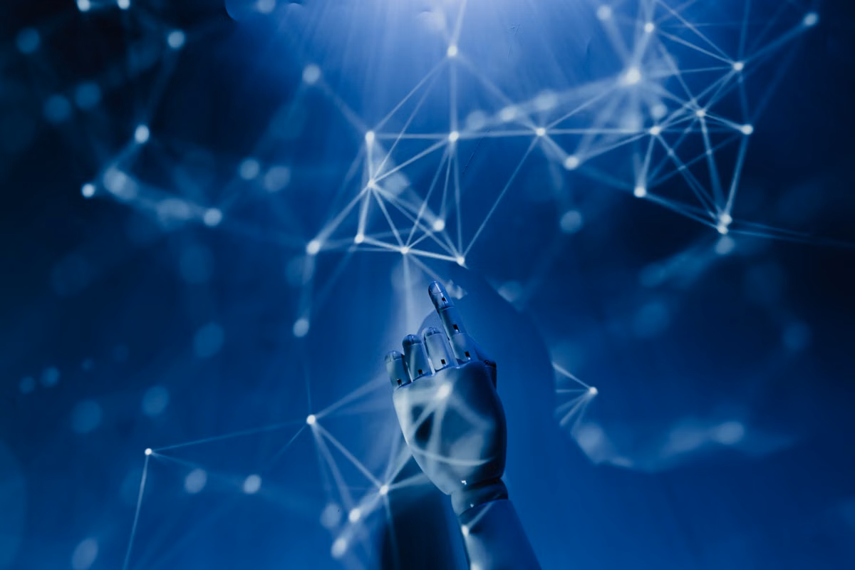 A robotic hand reaching into a digital network symbolizing AI technology